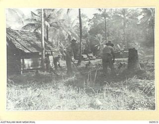 MILNE BAY, NEW GUINEA. 1943-01. TROOPS CLEANING UP AT HEADQUARTERS, ROYAL AUSTRALIAN ARTILLERY, 5TH DIVISION