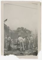 Litter Bearers in Front of Destroyed Motor Torpedo Squadron 3 Warehouse