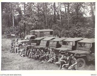 RABAUL, NEW BRITAIN, 1945-11-25. TROOPS IN THE RABAUL AREA ARE PROVIDED WITH ENTERTAINMENT BY MOBILE CINEMAS OF 5 BASE SUB AREA. SHOWN, THE FIVE JEEPS AND TRUCK OF MOBILE CINEMAS LINED UP AT THEIR ..