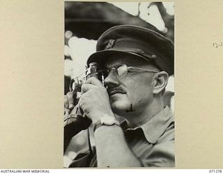 SCARLET BEACH, NEW GUINEA, 1944-03-16. NX35034 COLONEL J.C. BELISARIO DSO (1), COMMANDING OFFICER OF THE 2/5TH GENERAL HOSPITAL, USING HIS CONTAX CAMERA WHILE TOURING FORWARD MEDICAL UNITS ..