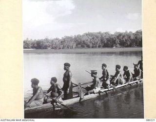 HANSA BAY, NEW GUINEA. 1944-07-08. A SECOND LAKATOI FOLLOWING A PATROL OF NO.5 PLATOON, A COMPANY, 1ST PAPUAN INFANTRY BATTALION DOWN THE RIVER. THE VILLAGE "DOCTOR BOY" (WEARING CAP) ACCOMPANIES ..