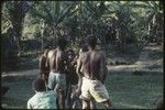 Local court case, child being pulled by men during a dispute over child's place between two groups