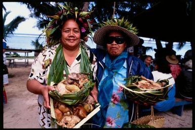 Women carrying baskets of food, Cook Islands