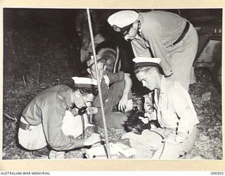 MALAGUNA MISSION, RABAUL, NEW BRITAIN, 1945-09-10. LIEUTENANT L. SMALL, RAN, ISSUES ORDERS TO MEMBERS OF A DETACHMENT OF A NAVAL WIRELESS TEAM, RAN, WHICH WAS LOANED TO THE ARMY FOR SHIPSHORE ..