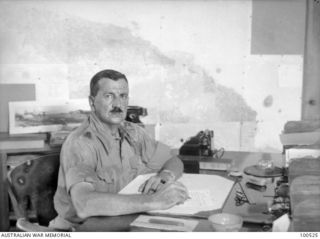 Port Moresby, New Guinea. 1944-07-08. Portrait of Major General B. M. Morris DSO, General Officer Commanding, Australian New Guinea Administrative Unit (ANGAU), sitting at his desk