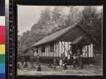 Portrait of men, women and children outside mission building, Mailu, Papua New Guinea, ca.1910-1920