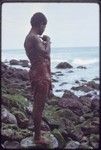 Kairiru: woman on rocky coastline