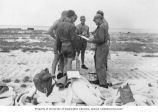 Expedition team members gathered on Enjebi Island before taking survey measurements on land, 1949