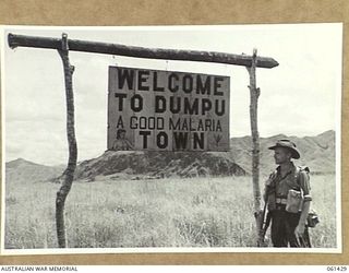 DUMPU, NEW GUINEA. 1943-12-06. ONE OF THE MANY SIGNPOSTS ERECTED AT THE DUMPU AIRTRIP, RAMU VALLEY, BY THE 18TH AUSTRALIAN ANTI-MALARIAL CONTROL UNIT IN AN EFFORT TO IMPRESS ON THE TROOPS THE ..