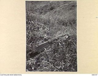 WIRUI MISSION, WEWAK AREA, NEW GUINEA, 1945-09-07. JAPANESE WATER COOLED .5 INCH BROWNING TYPE HEAVY MACHINE-GUN, FOUND IN ONE OF THE TWO JAPANESE WEAPON PITS WHICH PINNED DOWN TWO SECTIONS OF NO.8 ..