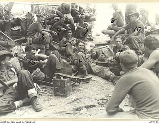 BOUGAINVILLE ISLAND. 1944-11-23. TROOPS OF THE 9TH INFANTRY BATTALION RESTING AT AN AMERICAN OUTPOST AS THE UNIT MOVES INTO THE FORWARD AREA TO TAKE OVER POSITIONS OCCUPIED BY THE 2ND BATTALION, ..