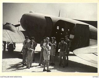 PERSONNEL OF NO. 16 SQUADRON, ROYAL NEW ZEALAND AIR FORCE ALONGSIDE THE DOUGLAS AIRCRAFT WHICH FLEW THEM FROM NEW ZEALAND. IDENTIFIED PERSONNEL ARE:- FLYING OFFICER C. DERBY (1); PILOT OFFICER L. ..