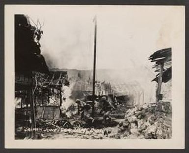 [United States Marines Moving Past Burning Houses in Garapan, Saipan]