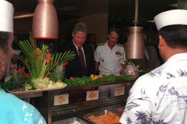 President William Jefferson Clinton and Adm. Charles R. Larson, commander-in-chief, U.S. Pacific Command, look at breakfast selections as they stand in the serving line at the enlisted galley during Clinton's tour of area military installations