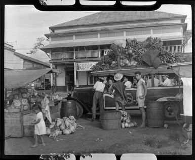 Fruit stall, Papeete, Tahiti, showing large amounts of fruit on top of a bus