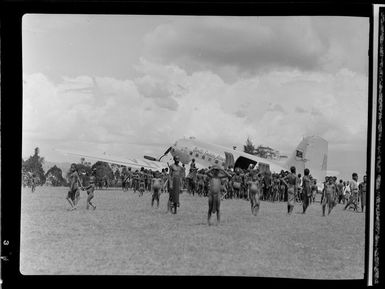 Locals at the arrival of a Qantas Empire Airways DC3 flight, Kerowagi, Papua New Guinea