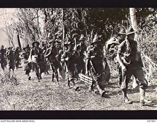 NADZAB, NEW GUINEA. 1943-09-20. "C" COMPANY, 2/16TH BATTALION, 21ST AUSTRALIAN INFANTRY BRIGADE, MOVING TO THEIR AIRCRAFT FOR THEIR SHIFT TO KAIAPIT. SHOWN: WX3865 LIEUTENANT L. D. BREMNER (1); ..