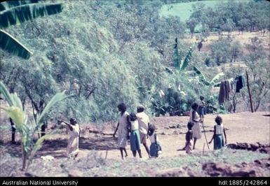 Indigenous people walking along a path