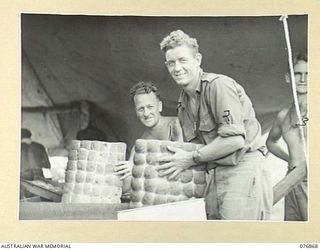 JACQUINOT BAY, NEW BRITAIN. 1944-11-08. BAKERS OF THE 14/32ND INFANTRY BATTALION PLACING BREAD ROLLS INTO CONTAINERS FOR DESPATCH TO THE VARIOUS SECTIONS OF THE UNIT. IDENTIFIED PERSONNEL ARE: ..