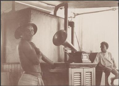 Chief of Nore Fou listening to a gramophone on the Southern Cross, Solomon Islands, 1906 / J.W. Beattie