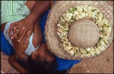 Woman in hat holding child, Mangaia