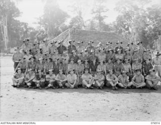 LAE AREA, NEW GUINEA. 1944-11-18. THE ORIGINAL PERSONNEL OF 2/1ST ARMY FIELD WORKSHOPS WHO FORMED THE NUCLEUS OF THE 2/7TH ADVANCED WORKSHOPS. THIRD FROM THE RIGHT IS NX2792 WARRANT OFFICER I, J. ..