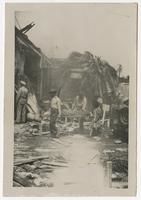 Litter Bearers in Front of Destroyed Motor Torpedo Squadron 3 Warehouse