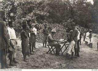 Lieutenant H N Leach, an Australian officer collecting native tax of 10% per annum