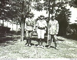 NEW IRELAND, 1945-10. TWO JAPANESE OFFICERS WITH AN INTERPRETER. (RNZAF OFFICIAL PHOTOGRAPH.)