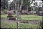 Wawela village clearing with small yam house (l), houses