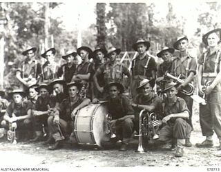 BOUGAINVILLE ISLAND. 1945-01-26. THE 57/60TH INFANTRY BATTALION SECTION OF THE COMBINED BAND WHICH PLAYED FOR THE INSPECTION OF THE 15TH INFANTRY BRIGADE BY THE GENERAL OFFICER COMMANDING, 3RD ..