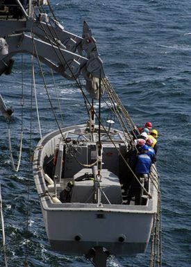 During a man overboard drill the US Navy (USN) Landing Craft Personnel Large (LCPL) is lowered over the side of the USN Tarawa Class Amphibious Assault Ship USS SAIPAN (LHA 2)