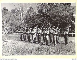 YALU, NEW GUINEA. 1945-08-03. WARRANT OFFICER 1 B.H. TURNER, REGIMENTAL SERGEANT MAJOR, NEW GUINEA TRAINING SCHOOL, INSTRUCTING STUDENTS IN RIFLE EXERCISES