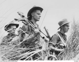 NEW GUINEA. RAMU VALLEY. 20 MARCH 1944. OUT ON THE PROWL FOR JAPANESE WELL FORWARD IN THE FINNISTERRES GO 2/6TH INDEPENDENT COMPANY PATROL MEMBERS REG HUTCHENS (CROYDON, NSW), BILL JEFFERY ..