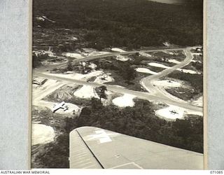 FINSCHHAFEN, NEW GUINEA. 1944-03-10. THE AIRCRAFT BAYS AND RUNWAYS AT DREGER AIRSTRIP VIEWED FROM AN AIRCRAFT