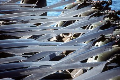 The folded rotor blades of CH-46E Sea Knight helicopters from Marine Medium Squadron 261 form a pattern on the deck of the amphibious assault ship USS GUAM (LPH-9). The ship is participating in operations off the coast of Lebanon