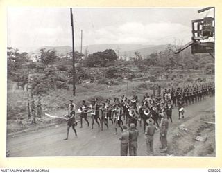 RABAUL, NEW BRITAIN. 1945-10-11. MEMBERS OF THE ROYAL PAPUAN CONSTABULARY LED BY THEIR BAND PASSING THREE WAYS DURING THE MARCH PAST. THE SALUTE WAS TAKEN BY MAJOR GENERAL K.W. EATHER, GENERAL ..