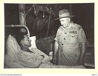 AITAPE, NEW GUINEA. 1945-03-20. GENERAL SIR THOMAS A. BLAMEY, COMMANDER-IN-CHIEF, ALLIED LAND FORCES, SOUTH WEST PACIFIC AREA (2), TALKING TO PRIVATE D.M. TILEY, 2/7 INFANTRY BATTALION (1), WHILE ..