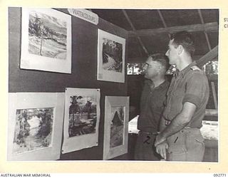 JACQUINOT BAY, NEW BRITAIN. 1945-06-06. CAPTAIN J.N. MCCOY, DEPUTY ASSISTANT DIRECTOR ORDNANCE SERVICE, 5 DIVISION (1) AND SERGEANT J.O. KIMBLE, ARMY EDUCATION SERVICE, HEADQUARTERS 6 INFANTRY ..