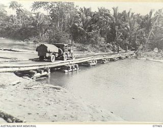BABIANG ROAD, AITAPE, NEW GUINEA. 1944-12-04. A JEEP CROSSING A NEW BRIDGE BUILT BY TROOPS OF NO. 9 PLATOON, 2/8TH FIELD COMPANY, ON THE AITAPE-DOGRETO BAY ROAD