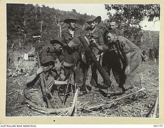 KARAWOP AREA, NEW GUINEA. 1945-04-20. MEMBERS OF 2/1 INFANTRY BATTALION WITH A CAPTURED JAPANESE 81 MM MORTAR, WHICH NOT LONG BEFORE HAD HELD UP THEIR ADVANCE AND CAUSED CASUALTIES. TROOPS OF THE 6 ..