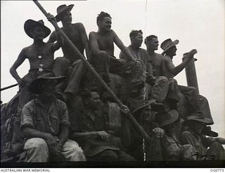 AT SEA IN THE ADMIRALTY ISLANDS AREA. 1944-03-18. RAAF AIRMEN ON THE DECK OF A LANDING CRAFT ON ITS WAY TO LOS NEGROS ISLAND