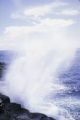 Oceania, waves crashing along shoreline of island in South Pacific