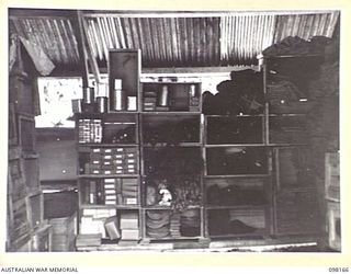 TOROKINA, BOUGAINVILLE. 1945-10-19. STORE HUT AT ASSISTANT DIRECTOR ORDNANCE SERVICE DUMP, 3 DIVISION, SHOWING OPEN SHELVES FOR THE STORAGE OF BROKEN STOCK