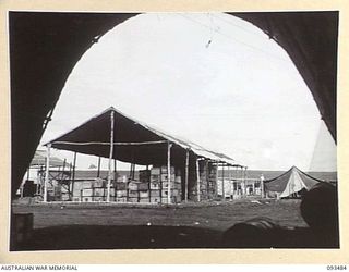 WEWAK AREA, NEW GUINEA. 1945-06-28. A NEW STORE SHED AT THE ASSISTANT DIRECTOR OF ORDNANCE SERVICE DUMP, HEADQUARTERS 6 DIVISION. MANY OF THESE SHEDS WERE CONSTRUCTED WITH THE ASSISTANCE OF ..