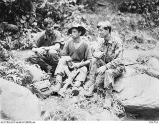 SALAMAUA AREA, NEW GUINEA. 1943-07-23. MEN OF "A" COMPANY, 2/5TH BATTALION, RESTING AFTER THE FIGHTING ON MOUNT TAMBU. LEFT TO RIGHT: WX13385 PRIVATE (PTE) J. BASSENELLE, STRETCHER BEARER; VX41527 ..