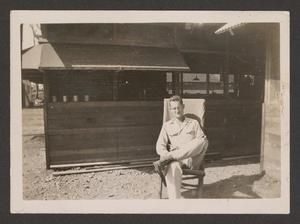 [Henry J. Cates Jr. Sitting on Chair, #1]
