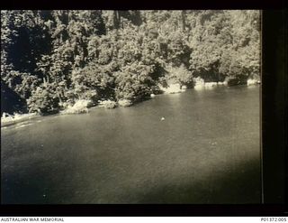 LINDENHAFEN, NEW BRITAIN. 1943-12-22. CAMOUFLAGED JAPANESE BARGES AT ANCHOR RIGHT AGAINST THE HEAVILY WOODED SHORE, TYPICAL OF THE TARGETS ENCOUNTERED BY BEAUFIGHTER AIRCRAFT OF NO 30 SQUADRON, ..