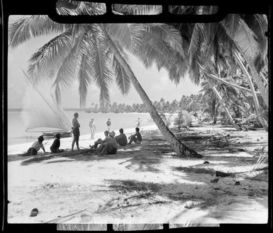 Tourists relax on beach, Akaiami, Aitutaki, Cook Islands