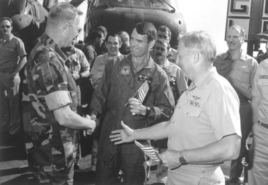 Colonel J. P. Faulkner, 22nd MAU commanding officer, and Captain J. M. Quarterman, USS GUAM (LPH 9) commanding offier, congratulate Major Gallagher of HMM-261 as the Marine runner with the most Olympic spirit during the GUAM's "Run Across the Atlantic". The trans-Alantic marathon began April 20th in Rota, Spain, and ended May 1st inside the 3-mile limit near Morehead City, North Carolina